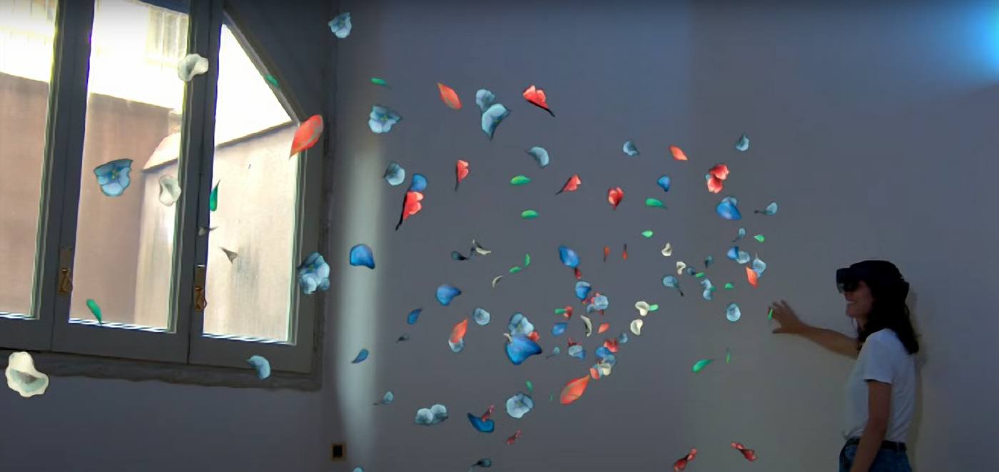 Visitor surrounded by floating holographic paper butterflies